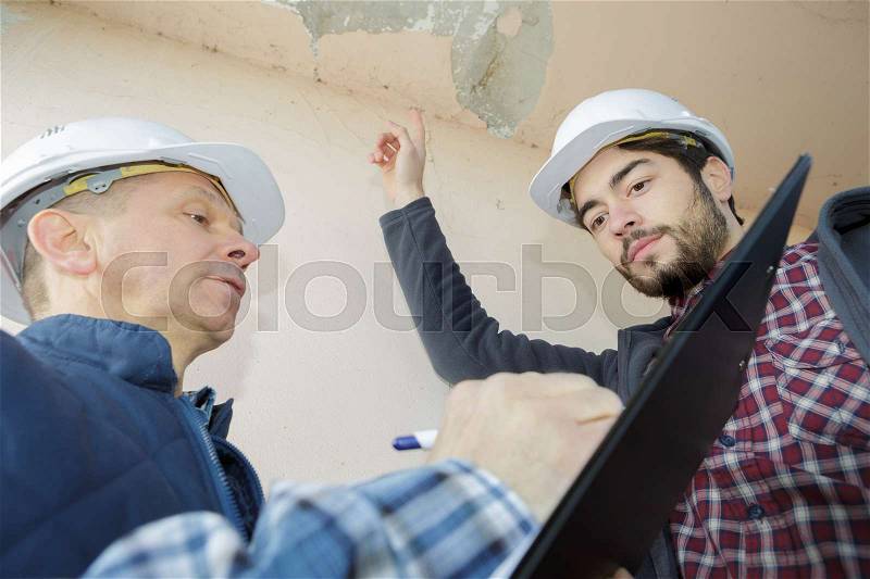 Listing the areas of defects in the building, stock photo