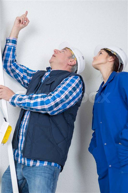 Pointing at the leak on the ceiling, stock photo