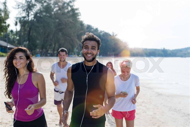 Group Of People Running, Young Sport Runners Jogging On Beach Working Out Smiling Happy, Fit Male And Female Joggers Multiracial Team, stock photo