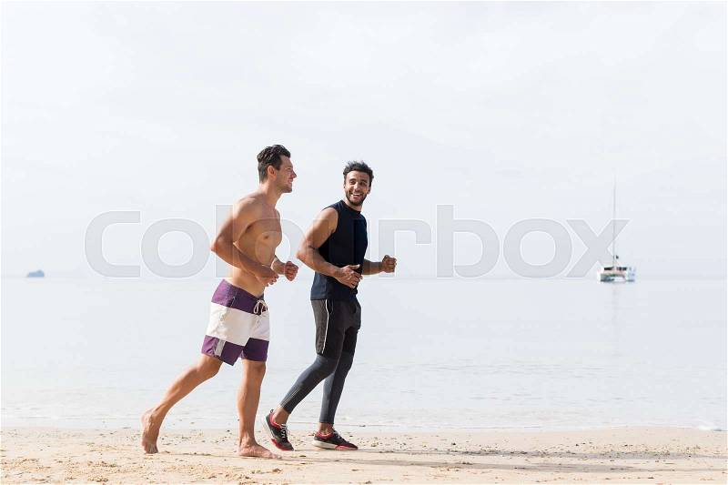 Two Men Jogging On Beach Together Guys Runners Training On Seaside Sport Fitness Workout Outdoors Healthy Lifestyle Concept, stock photo