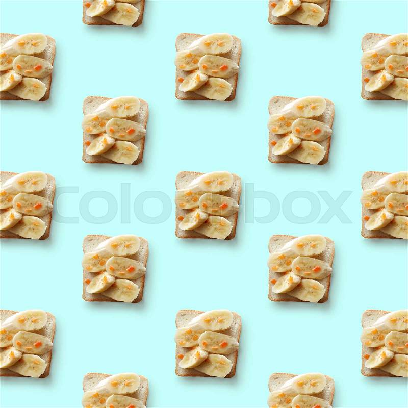 Sandwiches with banana on blue background, pattern flat lay, stock photo