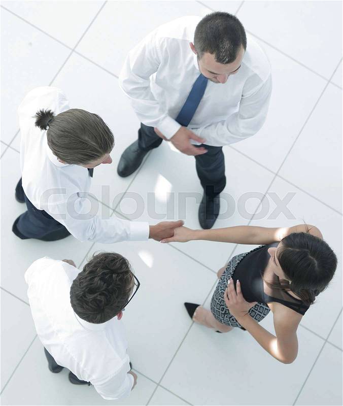 View from the top.welcome colleagues shaking hands in office lobby.photo with copy space, stock photo