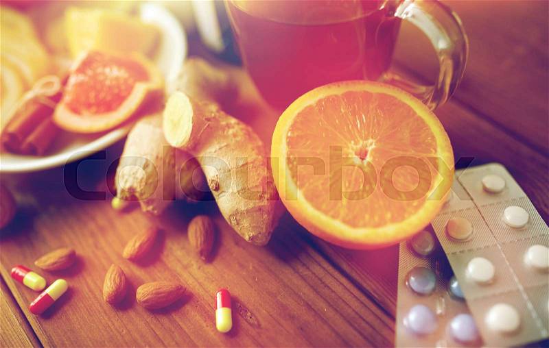 Healthcare and ethnoscience concept - traditional medicine and drug pills on wooden table, stock photo