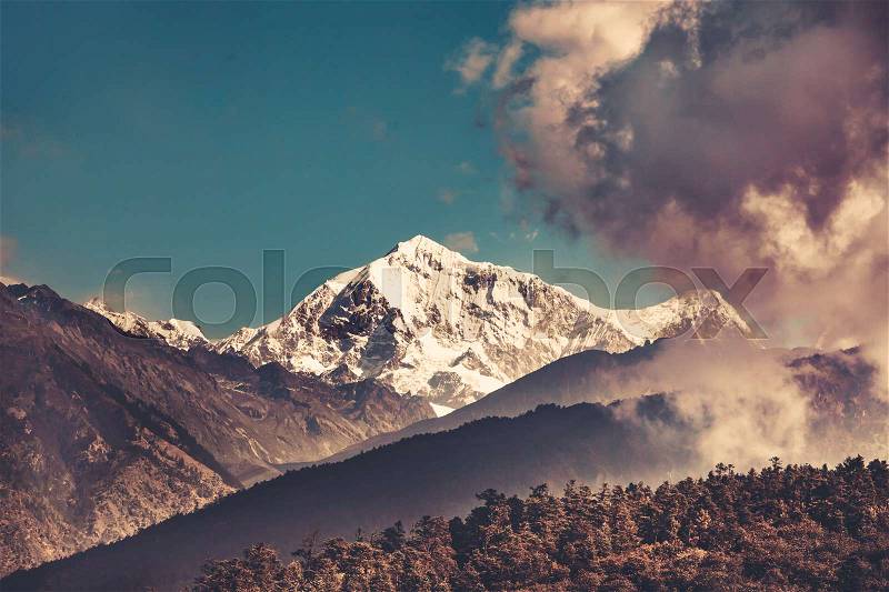 Himalayas mountain landscape. Trekking in Nepal. Magnificent views of the mountain range peak in clouds. Picturesque and gorgeous scene. Holiday, travel, sport, recreation. Retro vintage toning effect, stock photo