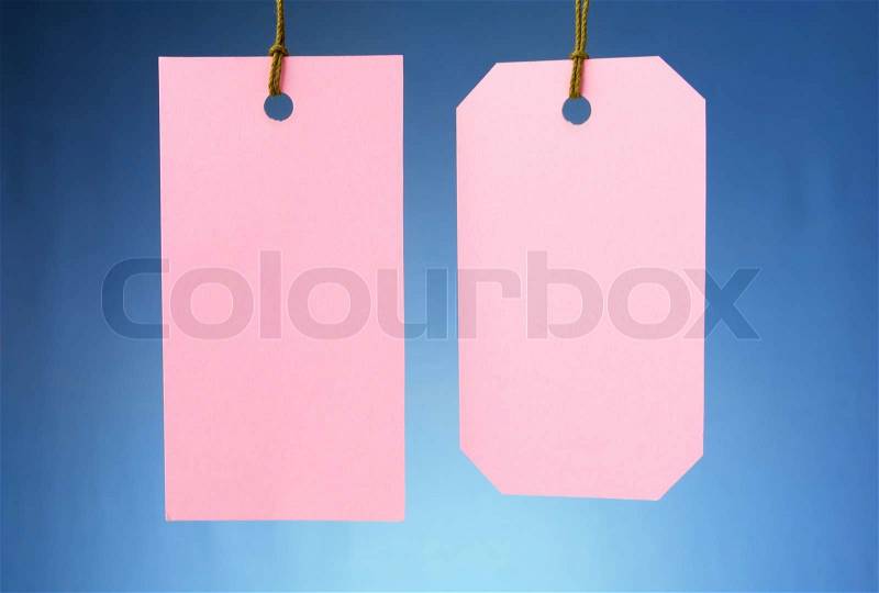 Two labels of different shapes on a blue gradient background, stock photo