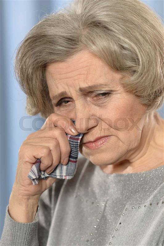 Portrait of a crying elderly woman close-up, stock photo