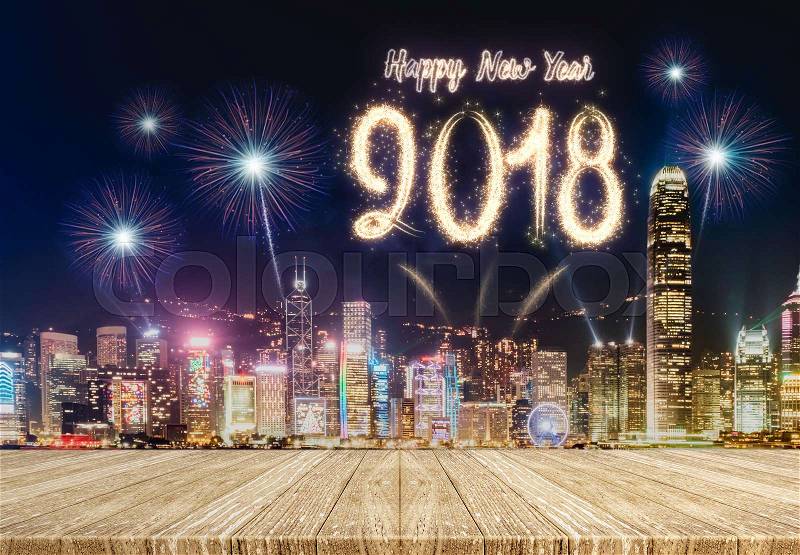 Happy new year 2018 fireworks over cityscape at night with empty wood plank table top,Mock up template for display or montage of product for holiday promotion advertising, stock photo