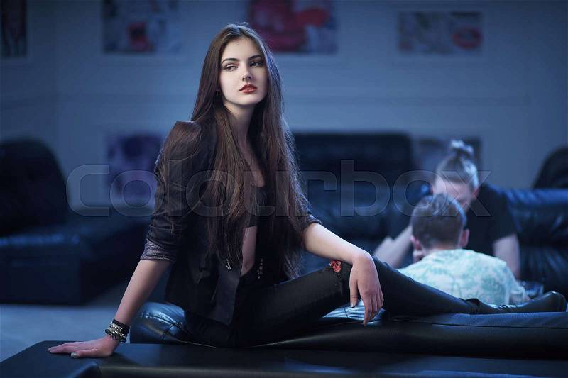 Concept: recreation, millennial, nightlife. Beautiful young woman relax in empty underground night club, stock photo