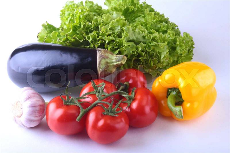 Fresh assorted vegetables, eggplant, bell pepper, tomato, garlic with leaf lettuce. Isolated on white background. Selective focus, stock photo