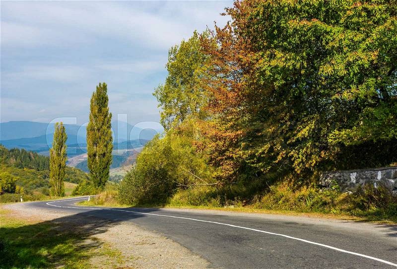 Winding countryside road through mountains. lovely autumnal scenery, stock photo