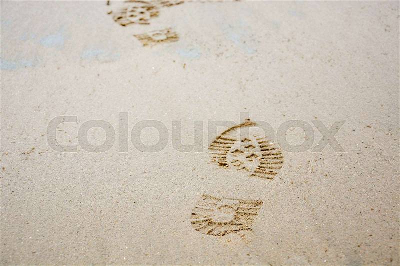 Several Footprints of shoes in the sand from the front, stock photo
