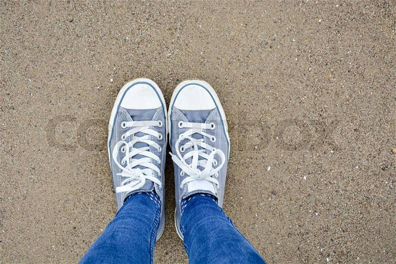 Standing with two shoes on sand as seen from above, stock photo