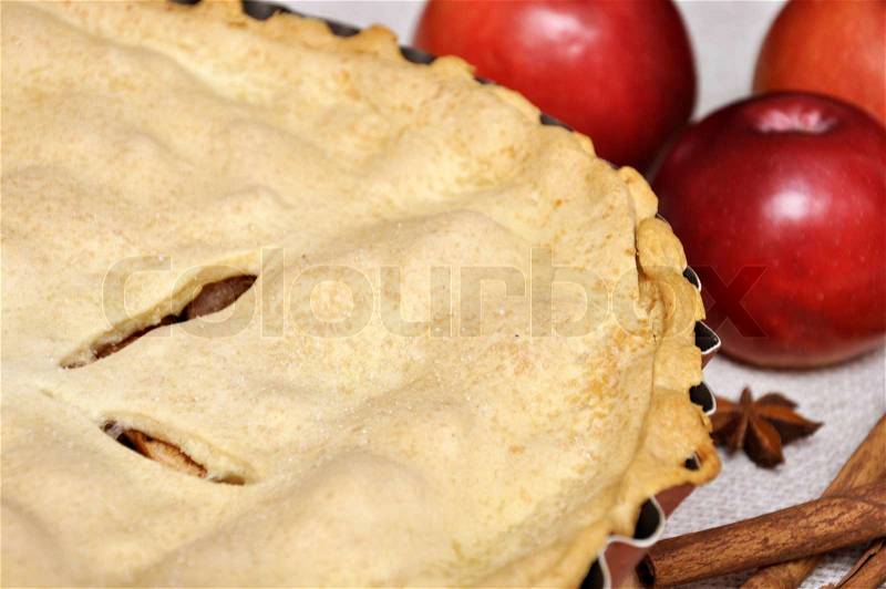 Freshly baked apple pie with apples in the background Macro with shallow dof, stock photo