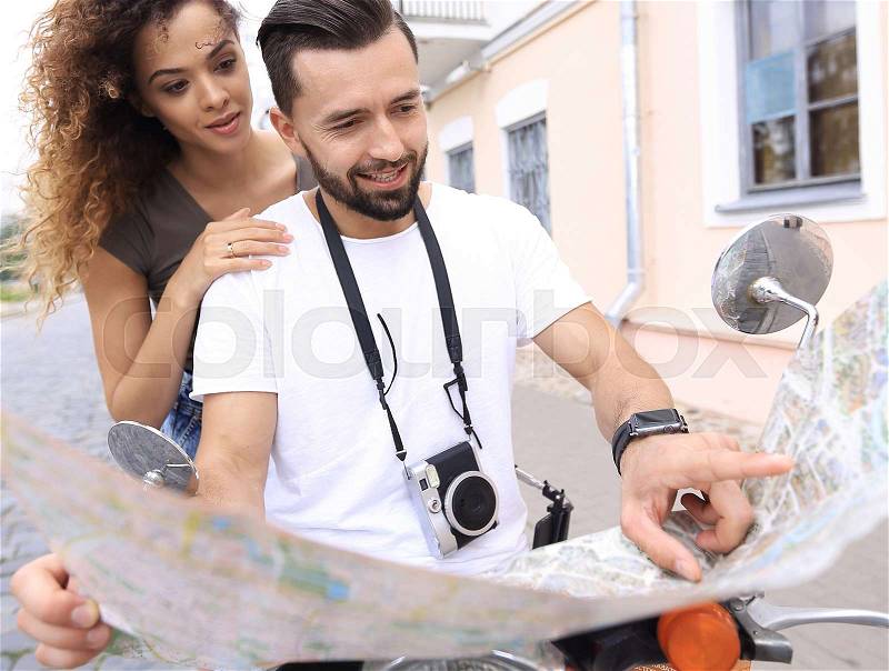 Scooter ride. Beautiful couple riding scooter together, stock photo