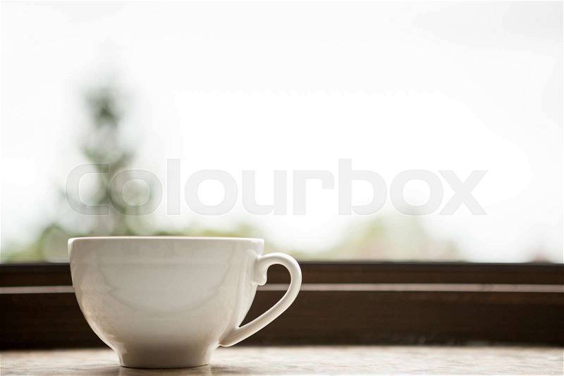 Coffee mug on a window sill. Morning coffee, stock photo