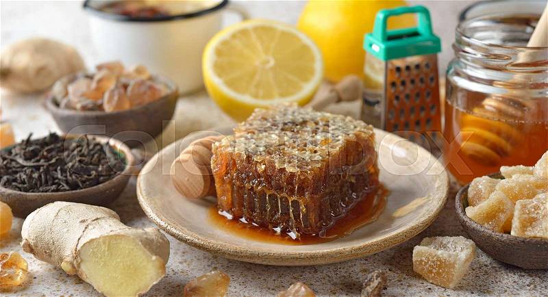Honey, lemon and ginger on a brown background, stock photo