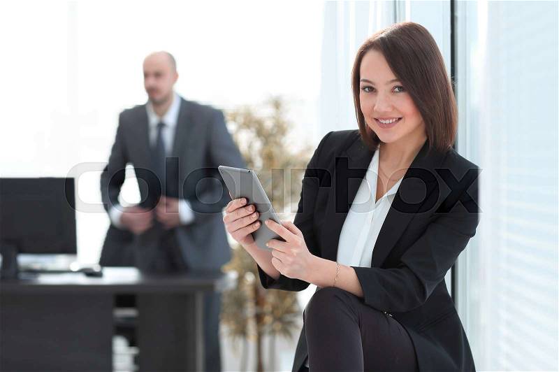 Business woman with tablet computer in the background of the office.photo with copy space, stock photo
