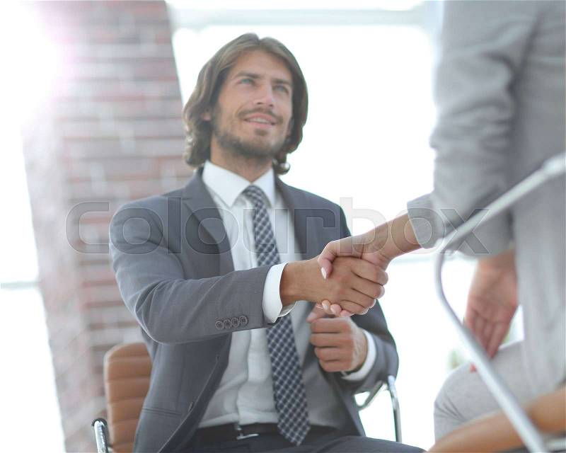 Successful job interview with boss and employee handshaking, stock photo