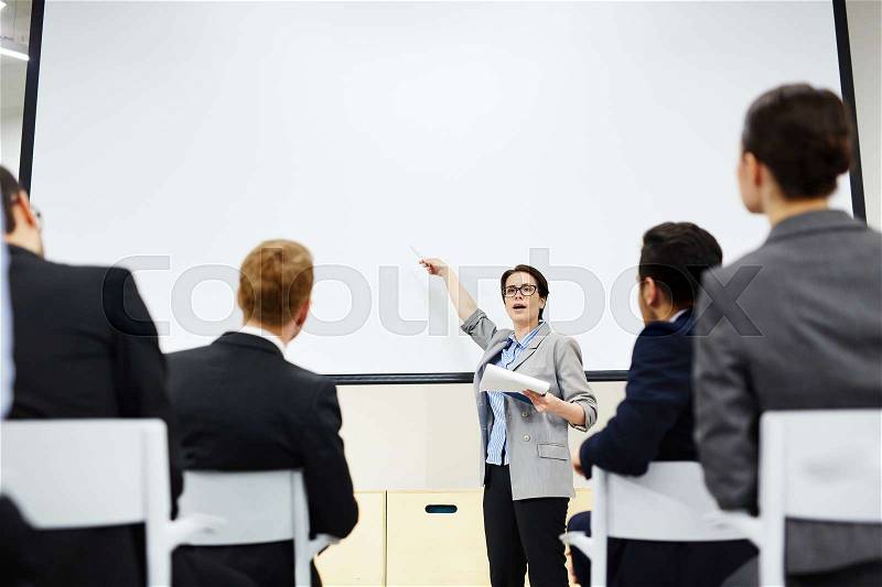 Intelligent businesswoman explaining her audience methods of financial increase, income and prosperity, stock photo