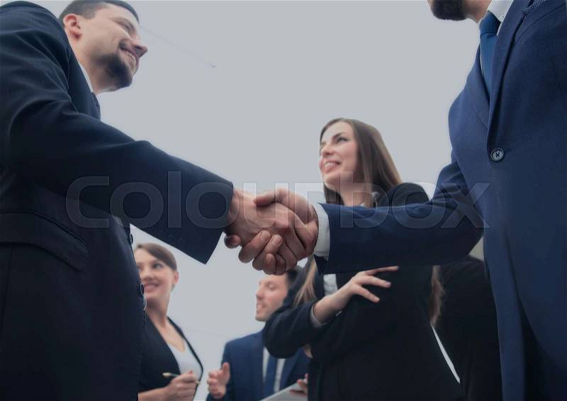 Business handshake. Business handshake and business people concept. Two men shaking hands over sunny office background. Partnership, Deal, stock photo