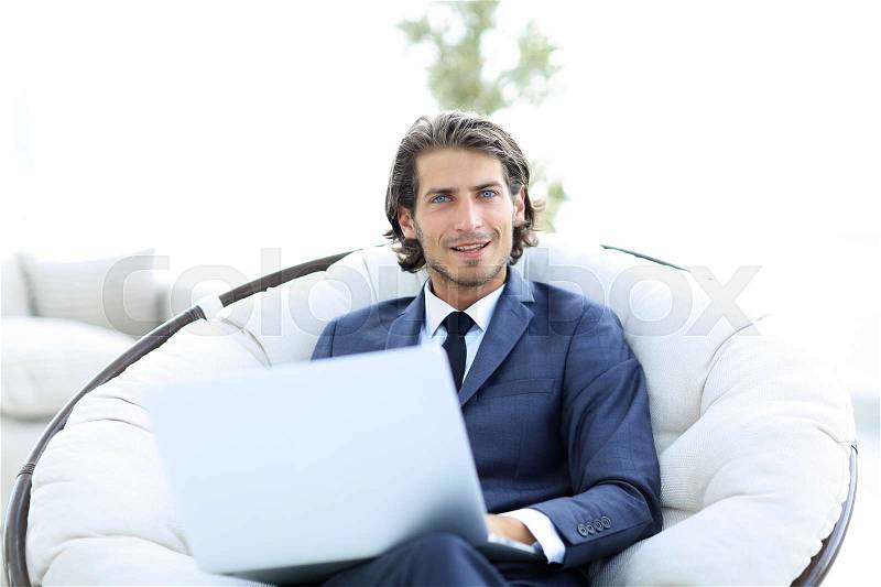 Close-up portrait of a successful business man with a laptop. business concept, stock photo