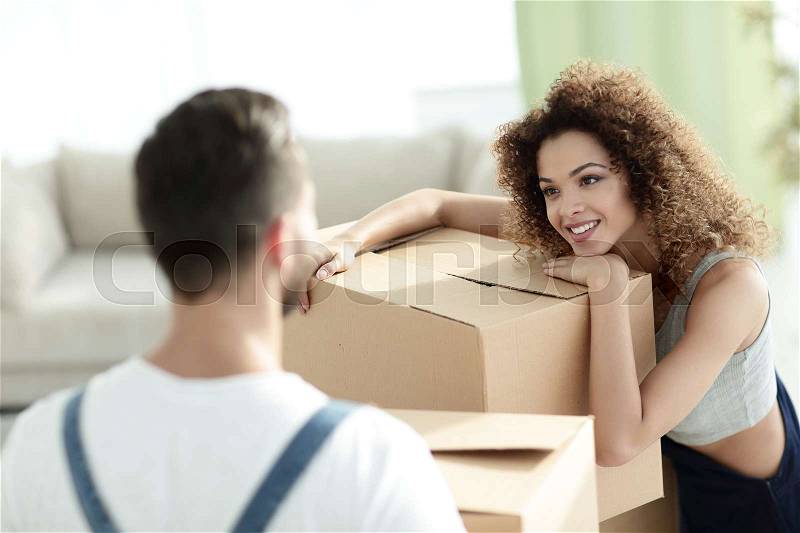 Young wife when moving to a new house. Concept of family happiness, stock photo