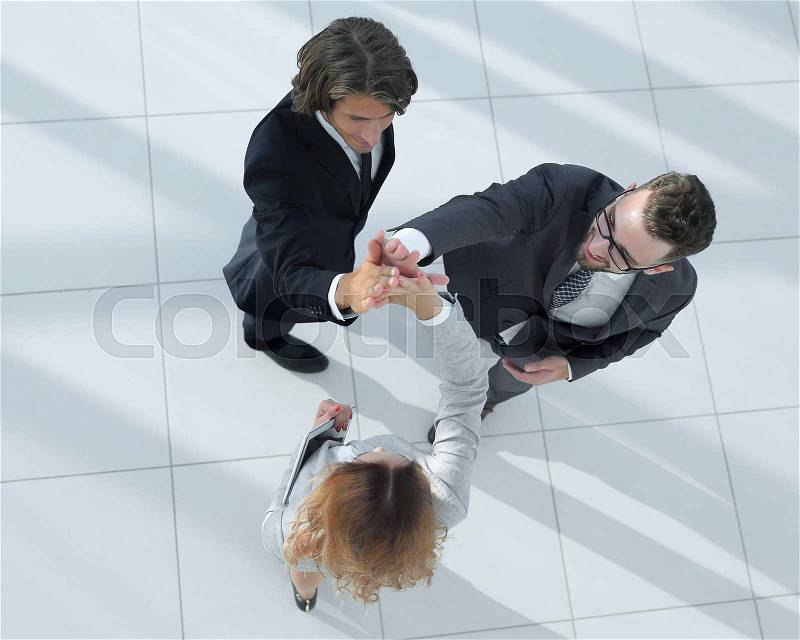 Smiling business people giving high five during teambuilding, stock photo