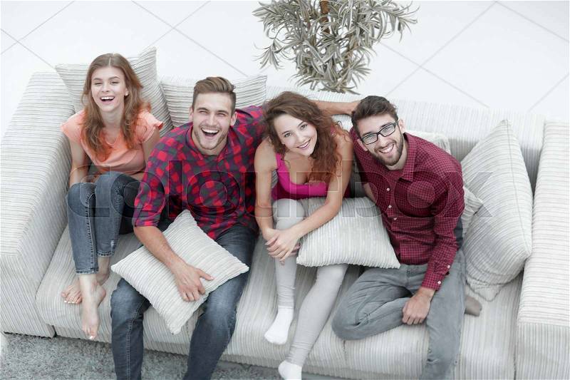 Cheerful group of friends laugh ,sitting on the couch. the concept of friendship, stock photo