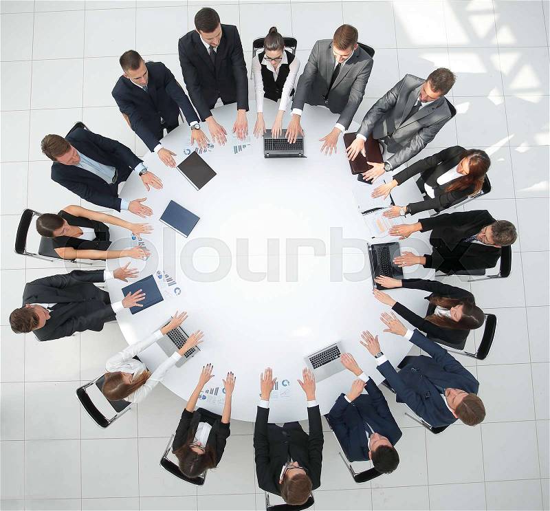 Business people sitting at the round table, and putting his palms on the table.the business concept, stock photo