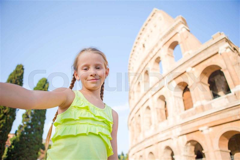 Little girl making selfie background Coliseum, Rome, Italy. Kid portrait at famous places in Europe, stock photo