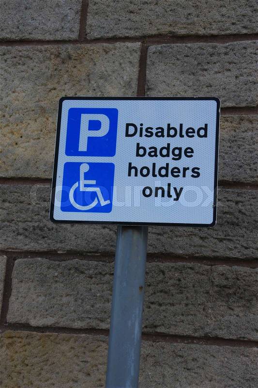 Traffic sign, disabled badge holders only in the residential area in the city Stirling in Scotland in the summer, stock photo