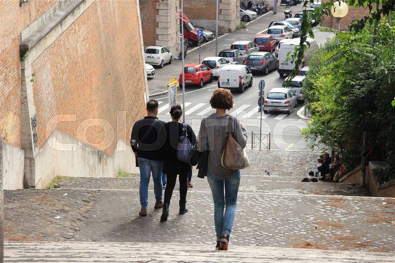 Parking place for cars and people are walking down of the staircase in the city Rome in Italia in the summer, stock photo