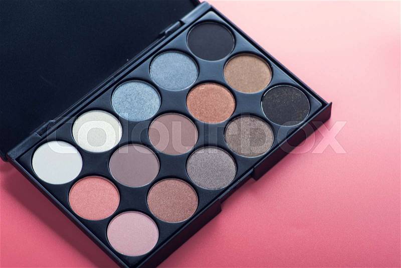 Cosmetic make-up palette on pink background, stock photo