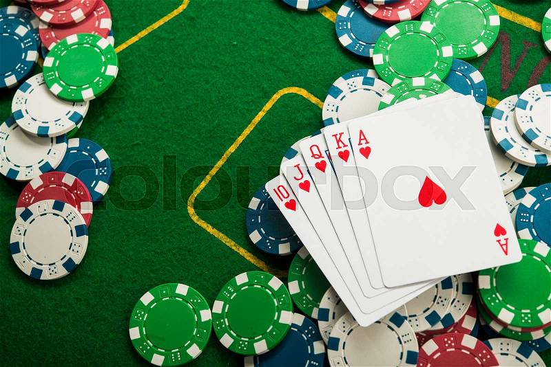 Royal flash on cards and poker chips on green casino table. success in gambling, stock photo