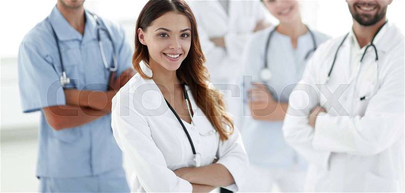 Attractive female doctor with medical stethoscope in front of medical group.photo with copy space, stock photo