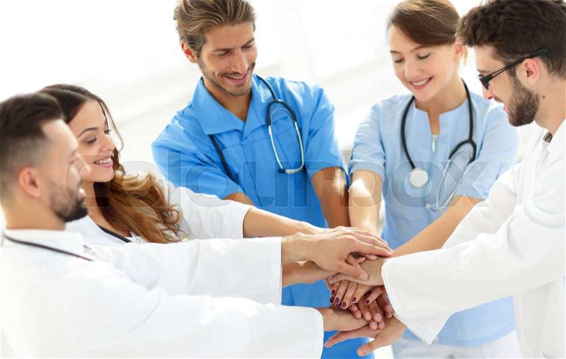 Doctors and nurses stacking hands. concept of mutual aid, stock photo