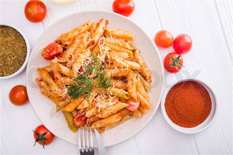 Delicious penne pasta on wood white table. tasty italian dinner.top view, stock photo