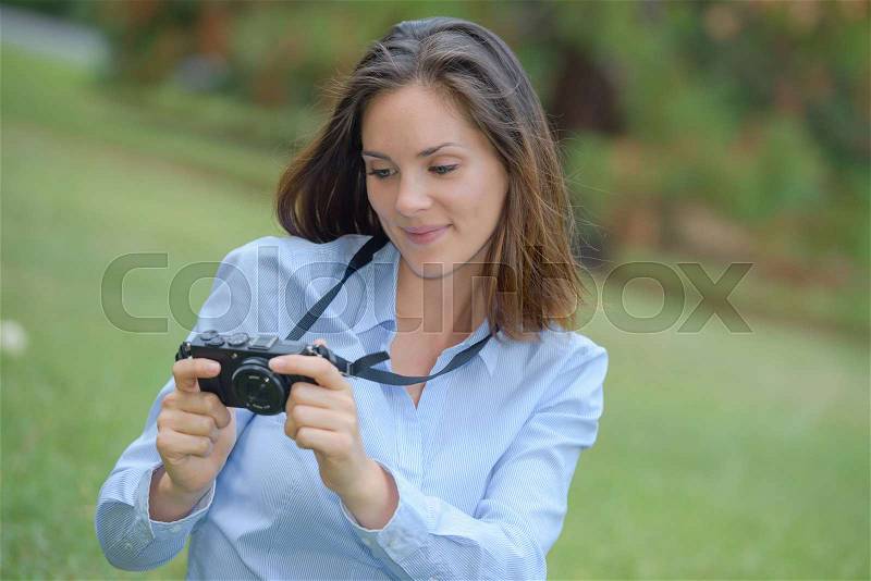 Lady looking digital camera screen, stock photo