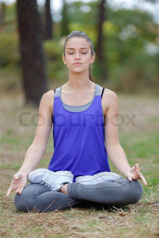 Woman doing a lotus yoga posture, stock photo