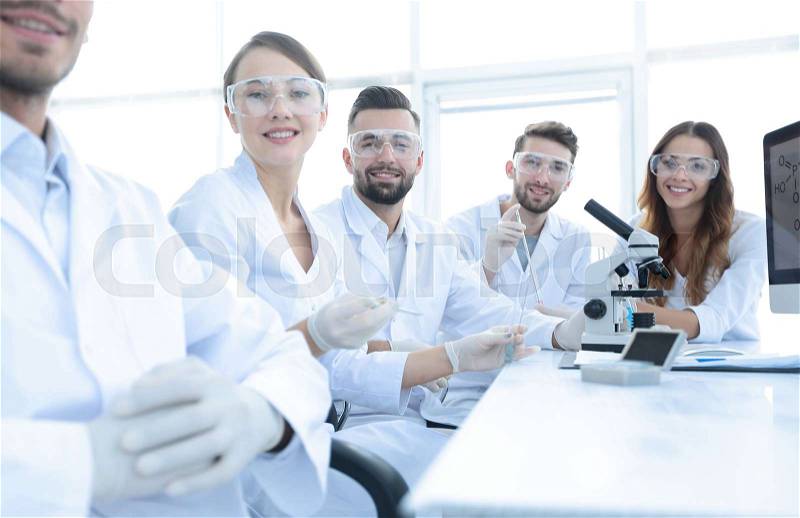 Head of the scientific project and research team at the workplace in the lab, stock photo