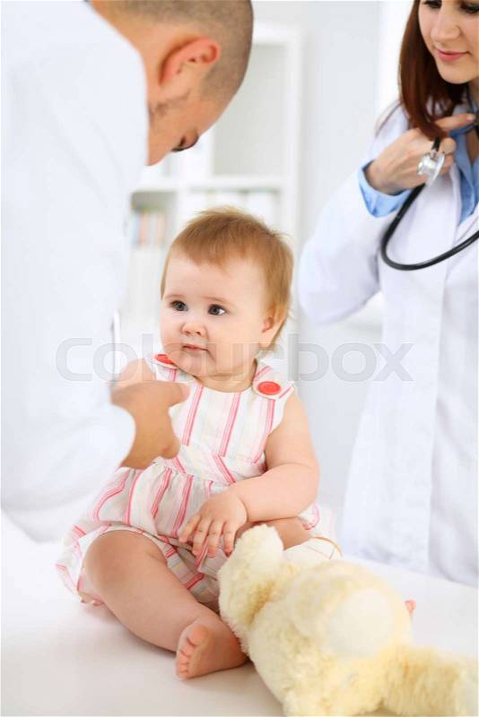 Happy cute baby after health exam at doctor\'s office, stock photo