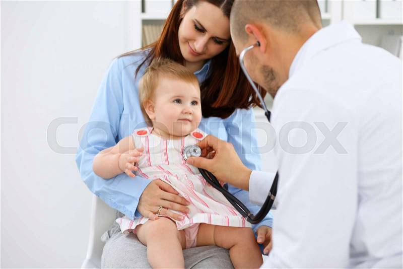 Happy cute baby with her mother at health exam at doctor\'s office, stock photo