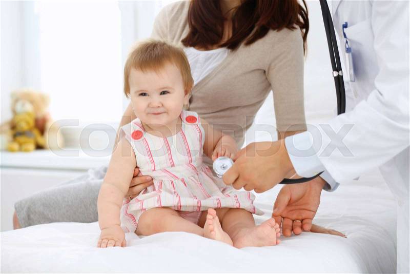 Happy cute baby with her mother at health exam at doctor\'s office, stock photo