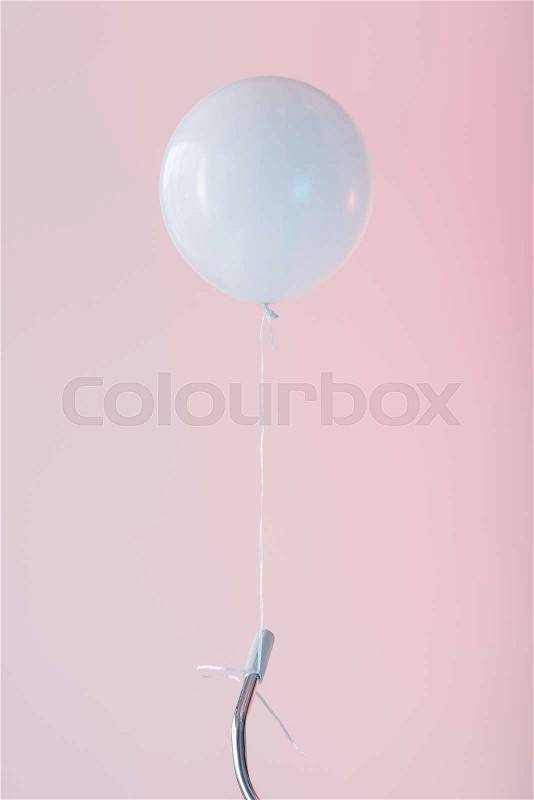 Cropped view of bicycle with white balloon, isolated on pink, stock photo