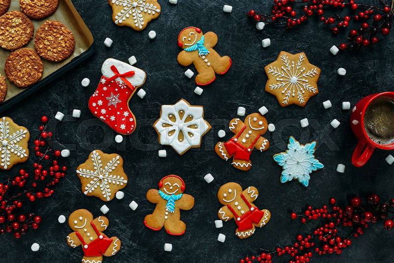 Top view of christmas gingerbreads and coffee on black tabletop, stock photo