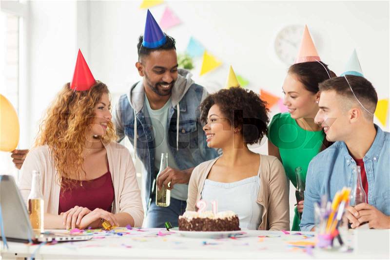 Corporate party and people concept - happy team with cake and non-alcoholic drinks celebrating colleague 21st birthday at office party, stock photo