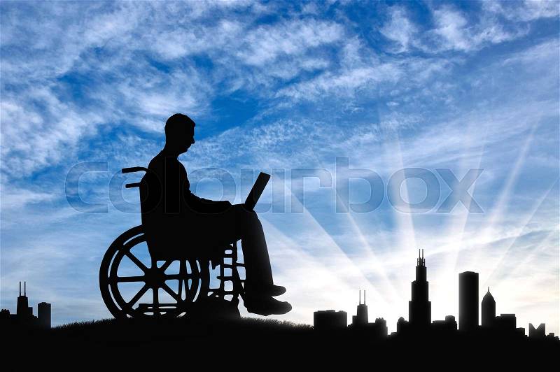 A disabled person in a wheelchair working with a laptop in hand on background of the city. The concept of the opportunity to work for people with disabilities, stock photo