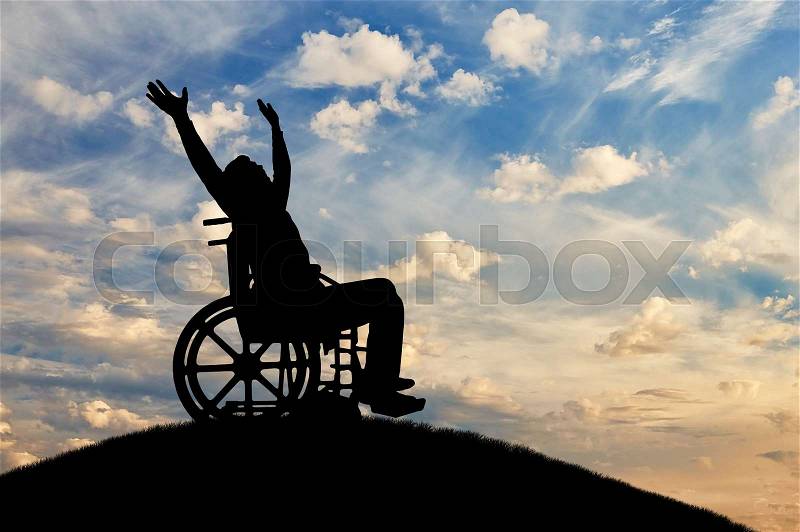 Happy disabled person in a wheelchair with arms raised. The concept of happy people with disabilities, stock photo