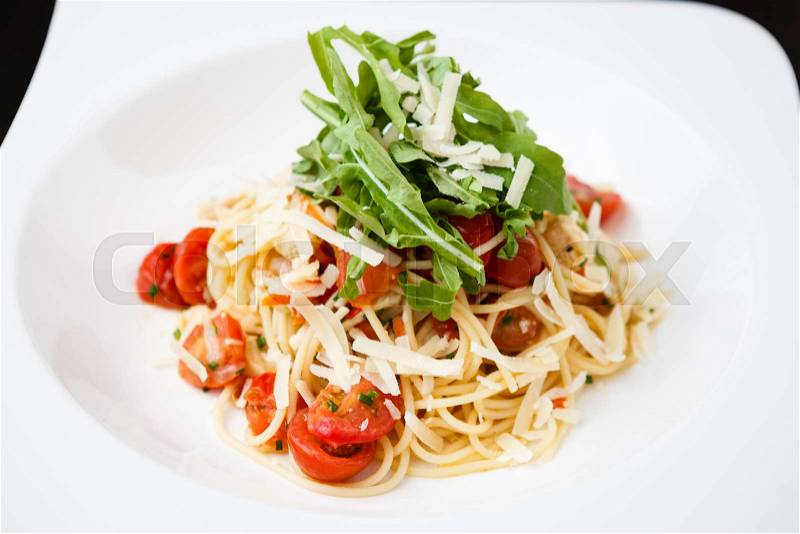 Classical chicken pasta with ruccola, tomatoes and cheese, stock photo