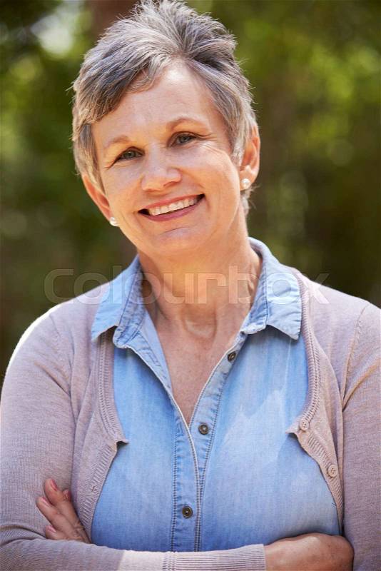 Outdoor Portrait Of Mature Woman With Folded Arms, stock photo